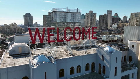rising over welcome sign in Brooklyn New York City