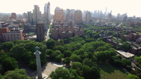 aerial over Prison Ships Martyrs' Monument at Fort Greene Park in Brooklyn with Manhattan skyline in background
