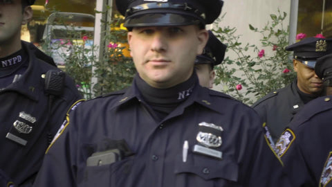 NYPD police officers - tracking shot scanning faces and uniforms on winter day in NYC