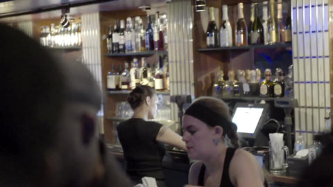 female bartender serving beer at nightclub
