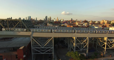 aerial over two subway trains on bridge NYC
