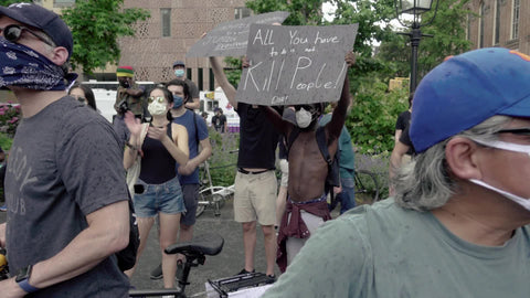 Black man holding all you have to do is not kill people sign at BLM rally in Washington Square Park NYC