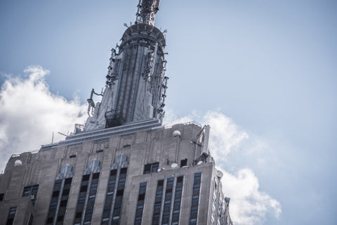 tight close-up shot of top of Empire State Building on grey hazy day