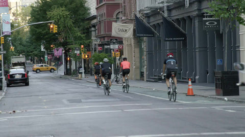 bicyclists riding in SoHo street on quiet summer morning in NYC