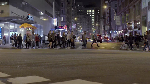 crowded crosswalk at Union Square at night - people crossing street in slow motion in New York City