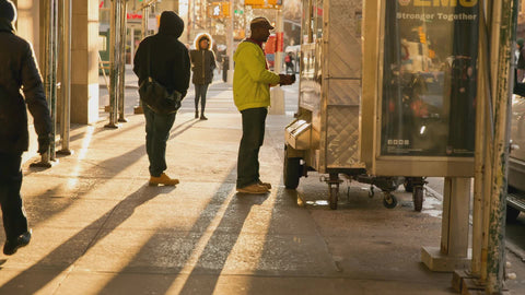 man paying for food at cart - street vendor in New York City NYC