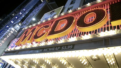 McDonalds sign lighting up on 42nd street off Times Square at night