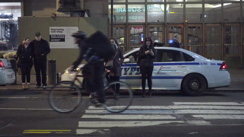 police car in front of Grand Central Terminal Station across crosswalk, woman on smart phone in 4K and 1080 HD in NYC