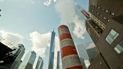 Freedom Tower with steaming construction smoke pipe in Downtown Manhattan in NYC