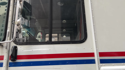 USPS truck and man riding bicycle in Financial District Downtown Manhattan New York City NYC