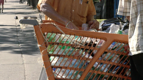 recycling in Harlem - cans and bottles from shopping cart in street