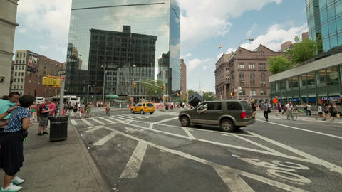 taxis driving through Cooper Square - panning to Starbucks on Astor Place on summer day in Manhattan