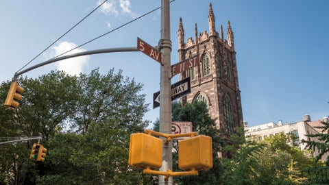 intersection of 5th Ave and 11th Street with First Presbyterian Church on sunny day in Manhattan
