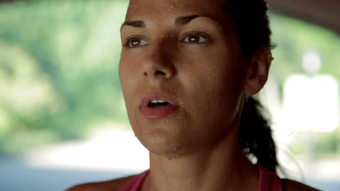 close-up on pretty athlete's face - attractive woman sweating and breathing after long run in Central Park
