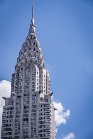 close-up of Chrysler Building famous Art Deco style skyscraper during day with blue sky in Manhattan NYC