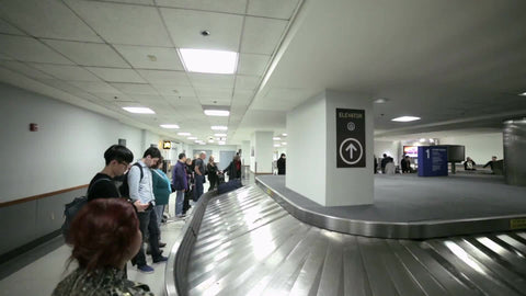 suitcases and bags on LaGuardia Airport baggage claim conveyor belt