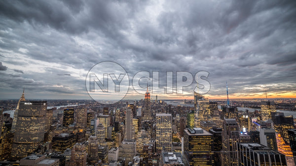 Empire State Building and Manhattan cityscape with skyscrapers from high view - cloudy sunset in early evening