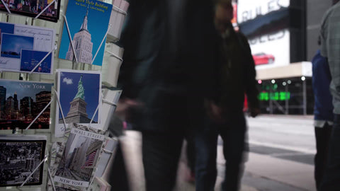timelapse of postcards and people walking by in Midtown Manhattan winter