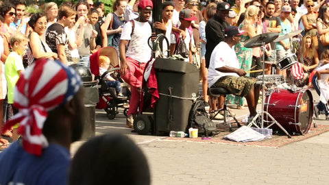 musicians and street acrobat performing - drummer in Washington Square Park on summer day in NYC