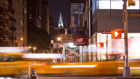 zooming back busy intersection of Broadway and Houston St, Chrysler Building view from SoHo in Manhattan - 4k timelapse NYC