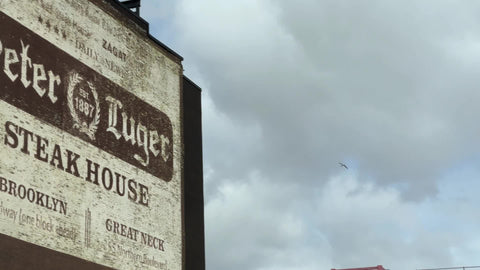 driving past large Peter Luger sign for famous steakhouse in Williamsburg Brooklyn New York City NYC