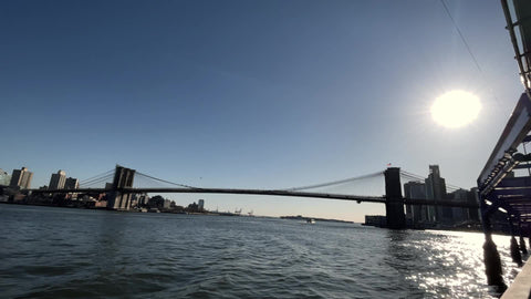 panning from Brooklyn Bridge to Manhattan Bridge across water of East River New York City NYC