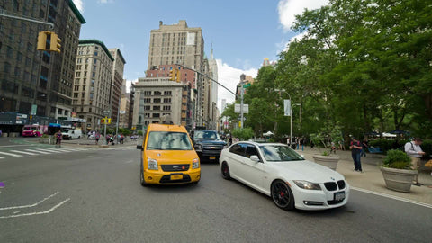 caravan taxi cab driving near Madison Square Park on 5th Ave