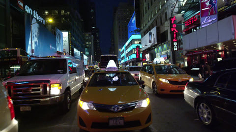 taxi cab driving through Times Square at night in slow motion in NYC