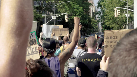 diverse crowd at BLM rally with signs