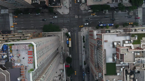 slow overhead aerial cars driving and buildings in Midtown Manhattan traffic NYC