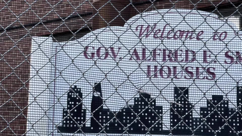 Smith housing project sign and fence in front of red brick building on Lower East Side Downtown Manhattan LES New York City NYC