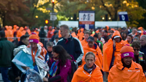 women in orange ponchos finished with Marathon smiling and celebrating their achievement 1080 HD in NYC