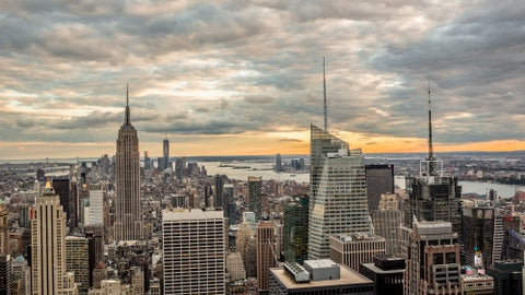 Empire State Building and Times Square skyscrapers in Manhattan cityscape at sunset from high view