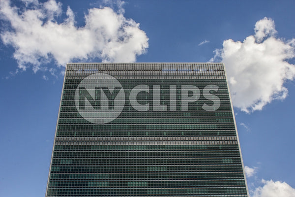 UN Building - close-up on top of United Nations from front - isolated on blue sky with clouds on beautiful sunny summer day
