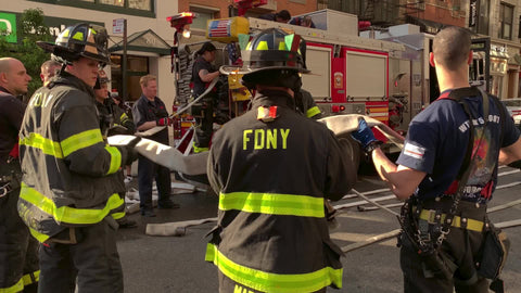 firefighters handing off hose working together - FDNY workers New York City NYC