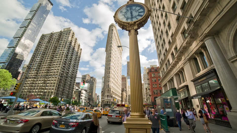 5th Ave and 23rd Street on summer day - famous clock and Flatiron Building