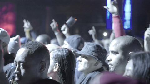 fans having fun at rap show - hip hop crowd in slow motion under smoky bright lights in slow motion