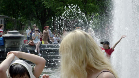 children playing in Washington Square Park water sprinkler on summer day - slow motion in NYC