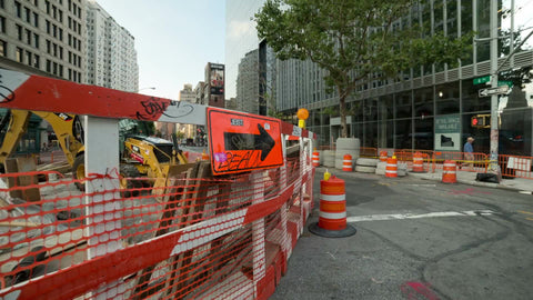construction site detour directions arrow and orange cones in Cooper Square in Manhattan NYC