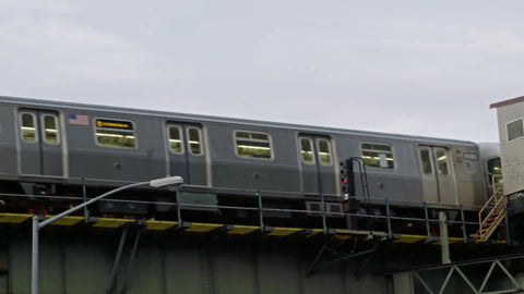 elevated subway train riding in slow motion on track