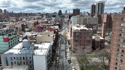 aerial over East Harlem moving sideways low uptown NYC