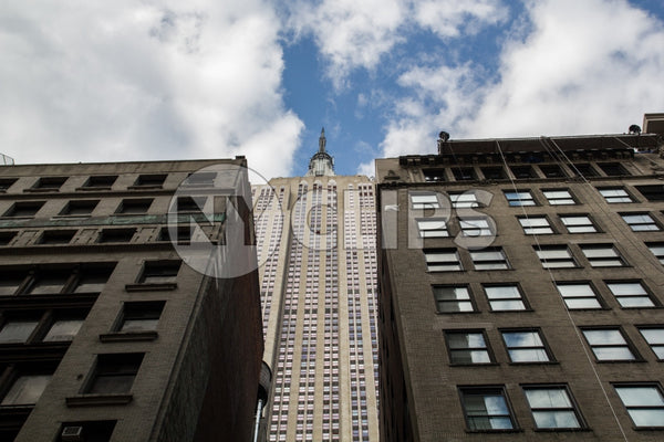 Empire State Building seen through two buildings from low view looking up