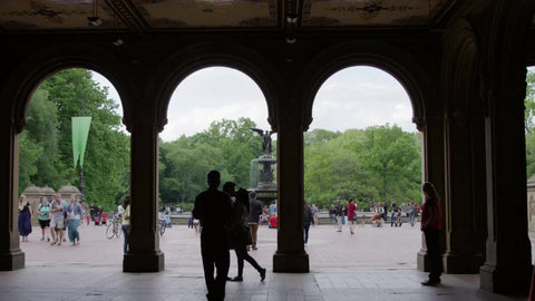 silhouette of couple kissing under Bethesda Terrace - photographer taking picture in Central Park