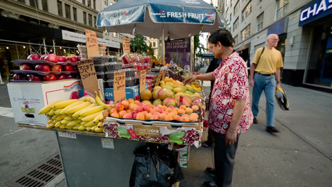 man selling fresh fruit in street - vendor in summer