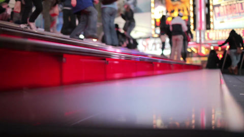 famous red steps in Times Square at night - tourists speaking different languages