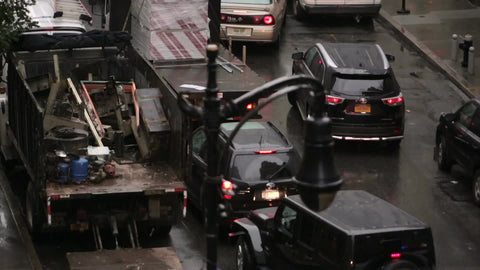 police siren in traffic - NYPD cop car with turret lights flashing in rain on NYC street