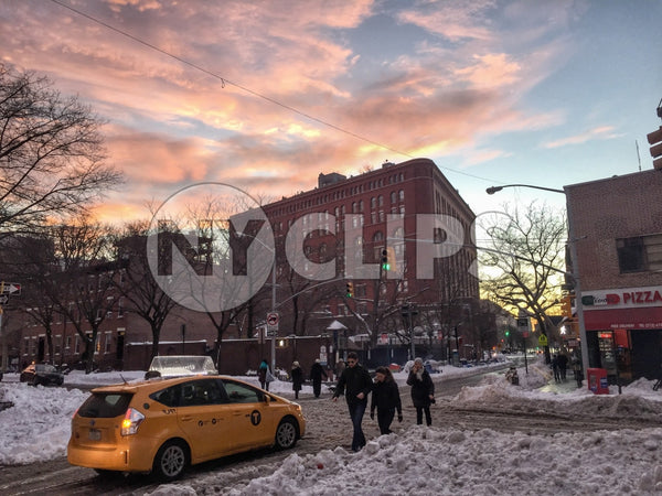 caravan taxicab on Lower East Side of Manhattan - people walking in snow - snowing at sunset in winter