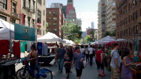 people walking in crowded street fair in Manhattan NYC