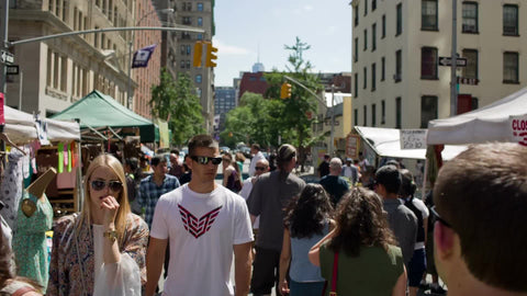 people walking through crowded street fair on hot summer day in NYC