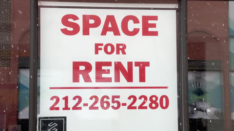 space for rent sign with number to call in empty retail store snowing winter Manhattan New York City NYC